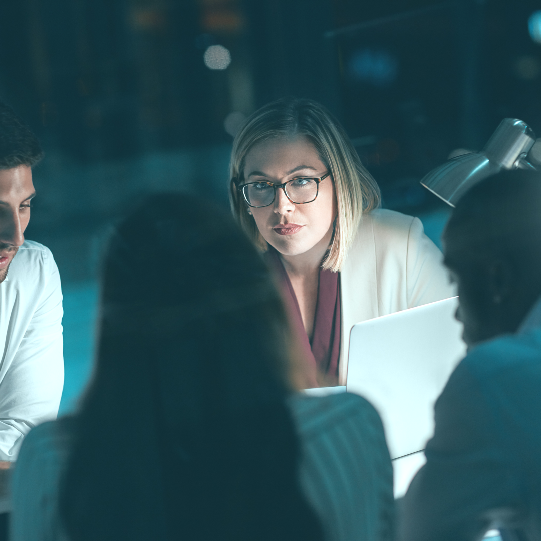 Team of energy experts looking serious around table