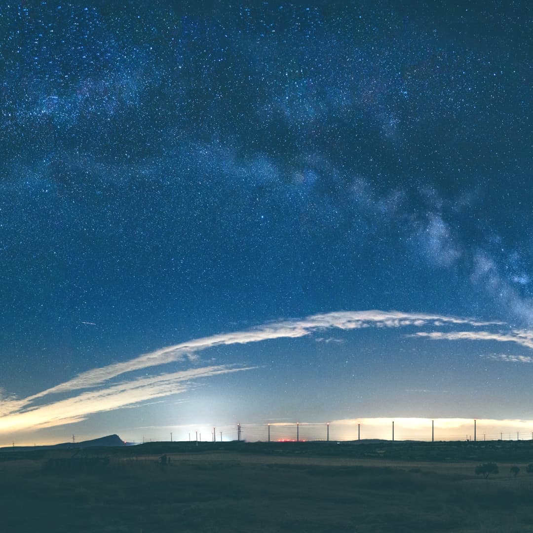 Starry sky with a line of pylons at the bottom