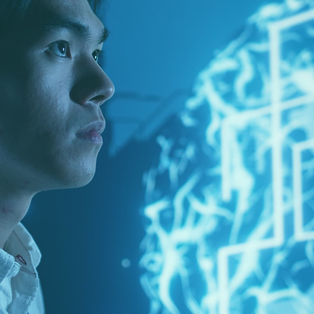 Young man looking off into the distance with a pattern of blue light behind him