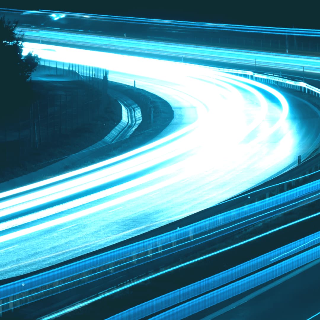 Bright blue light rays flowing round road