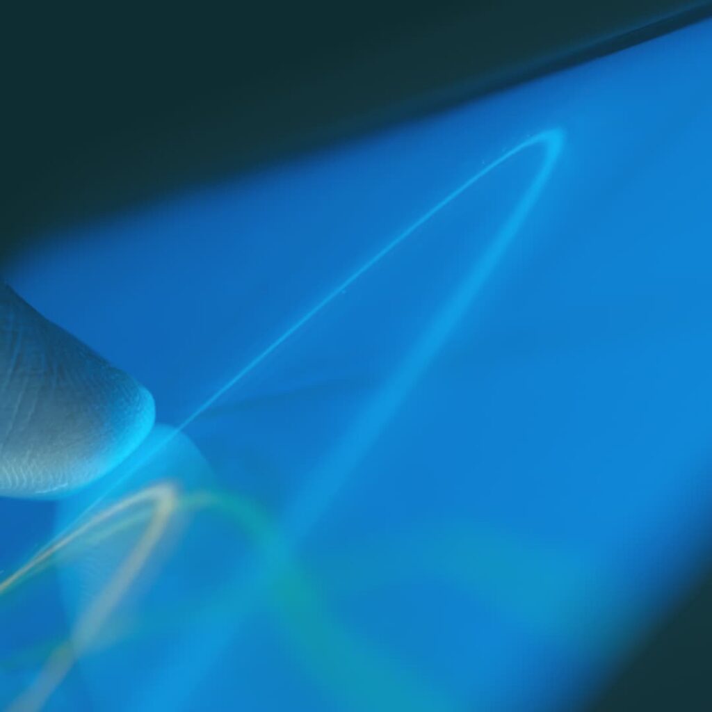 Hand touching screen showing data