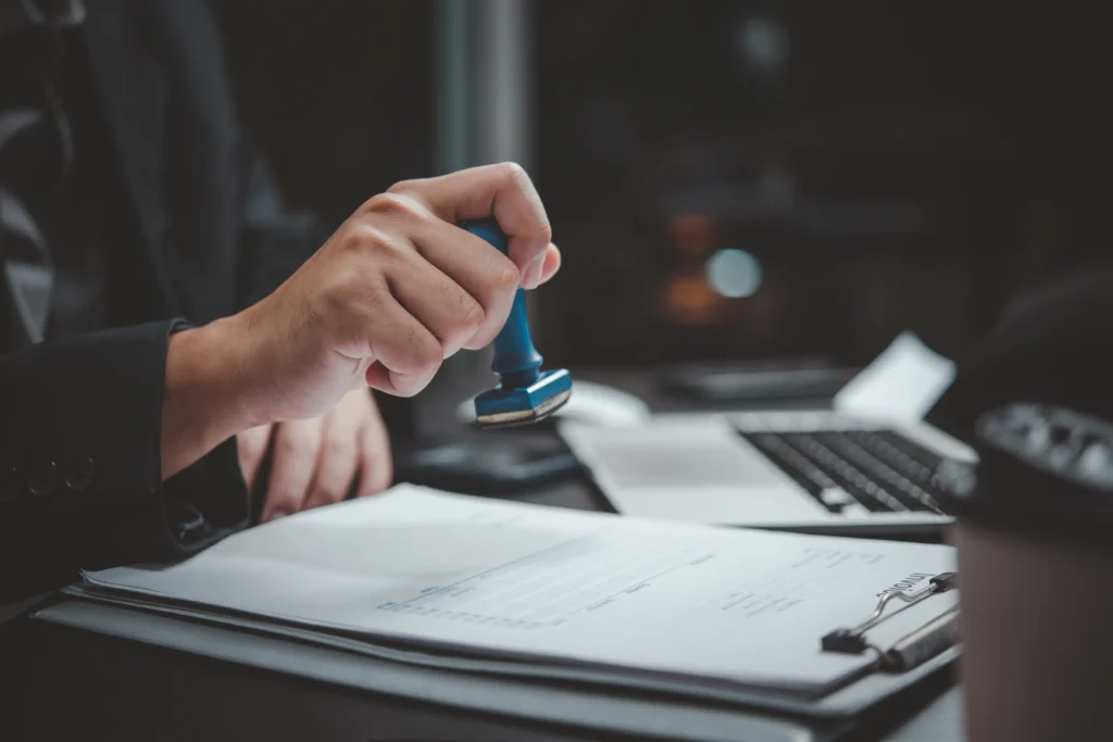 hand-hold-stamping-rubber-business-document-invoic-2026-03-19-23-08-18-utc